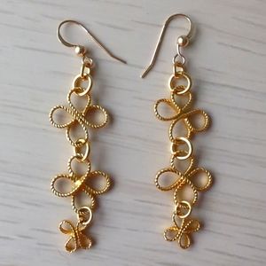 Gold colored fleur flower dangling earrings
